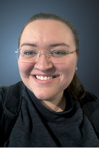 Katie Roush, librarian in glasses and black shirt